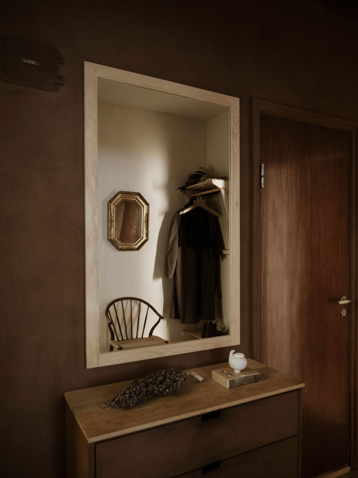 mirror with birch frame in a brown hallway